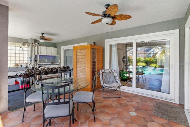 dining area with ceiling fan and a textured ceiling