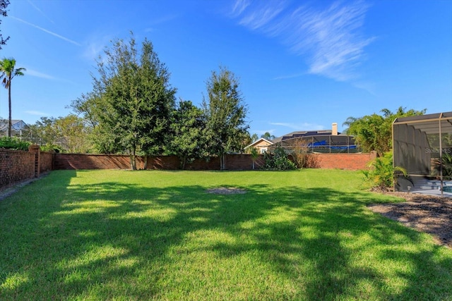 view of yard featuring glass enclosure