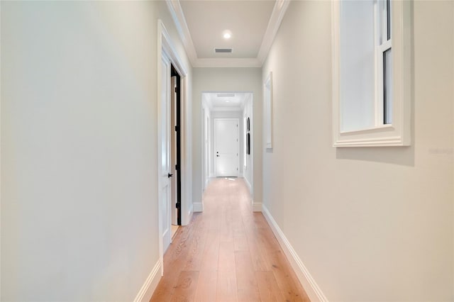 corridor featuring light hardwood / wood-style floors and ornamental molding