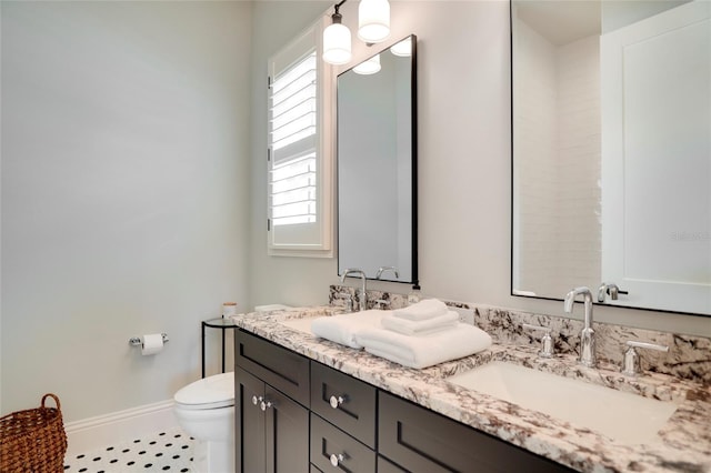 bathroom featuring vanity, toilet, and tile patterned floors