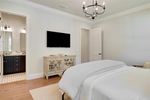 bedroom with light hardwood / wood-style flooring, a notable chandelier, connected bathroom, and crown molding