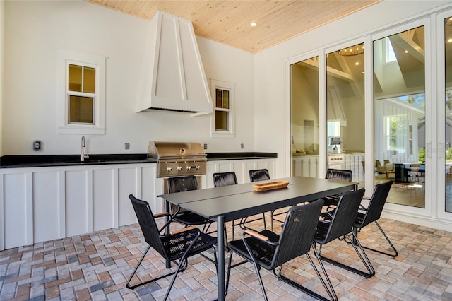 dining room featuring sink and wooden ceiling