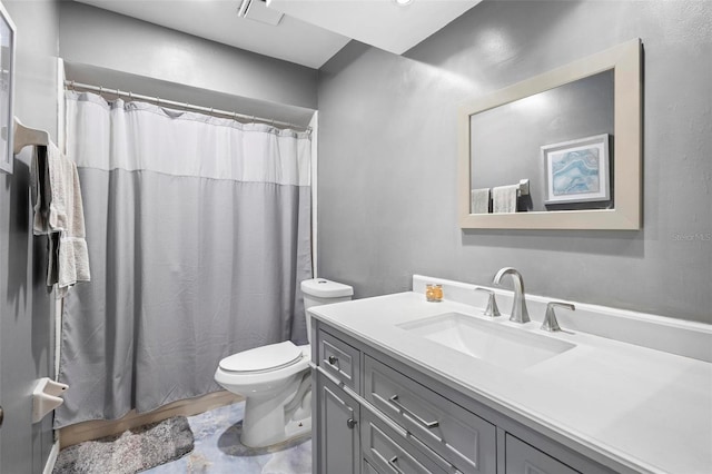 bathroom with vanity, curtained shower, and toilet