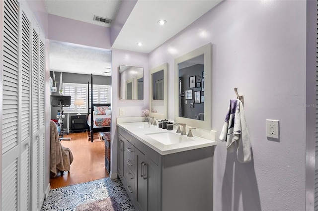 bathroom with vanity and hardwood / wood-style flooring