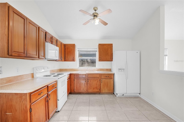 kitchen with light tile patterned floors, sink, vaulted ceiling, white appliances, and ceiling fan