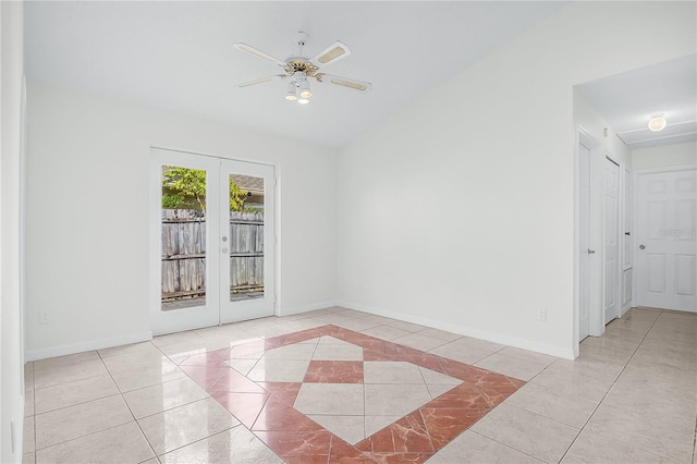 empty room featuring light tile patterned flooring, ceiling fan, lofted ceiling, and french doors