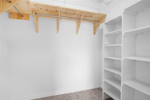 spacious closet featuring tile patterned flooring