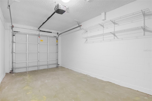 garage with concrete block wall and a garage door opener