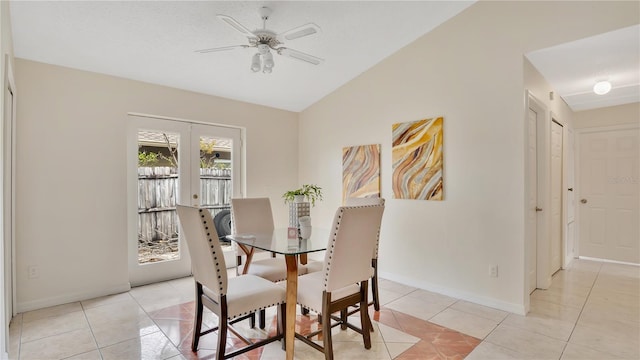 dining area with baseboards, lofted ceiling, french doors, light tile patterned flooring, and a ceiling fan