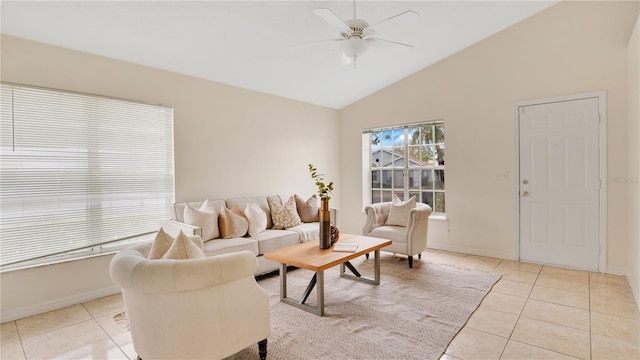 living room featuring lofted ceiling, light tile patterned floors, baseboards, and ceiling fan