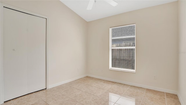 spare room with light tile patterned floors, baseboards, and a ceiling fan