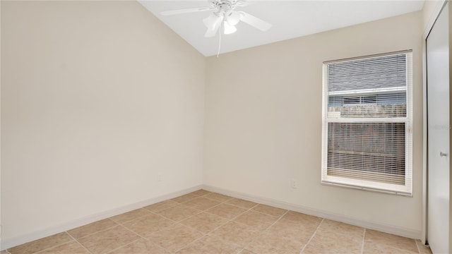 empty room featuring light tile patterned floors, ceiling fan, and baseboards