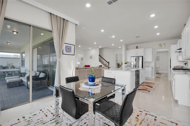 dining area with light tile patterned floors and sink