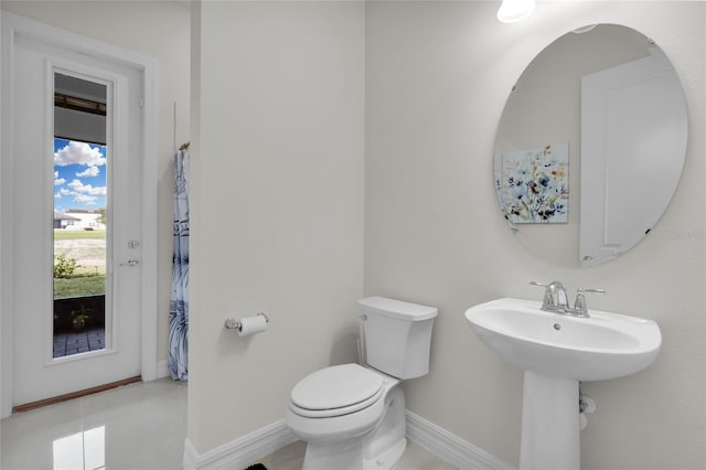 bathroom with tile patterned floors, toilet, and sink