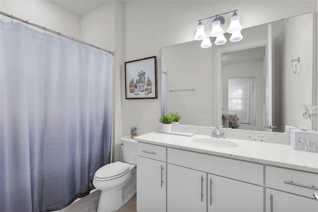 bathroom with hardwood / wood-style floors, vanity, and toilet