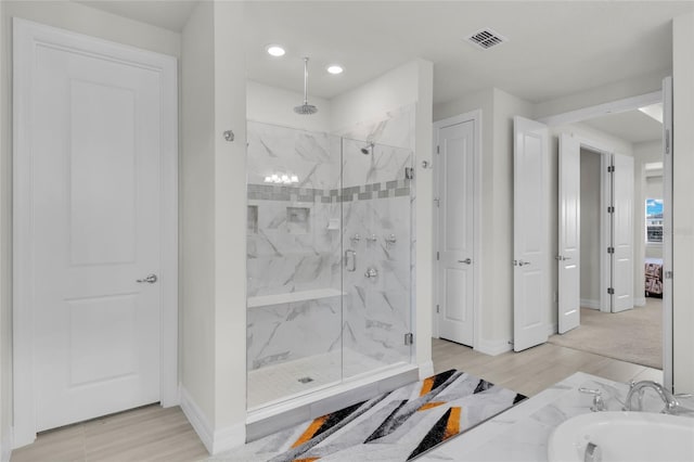 bathroom featuring hardwood / wood-style floors and walk in shower