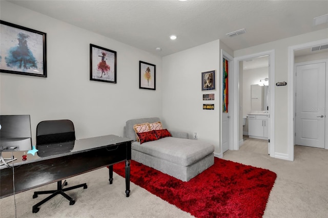 carpeted home office with a textured ceiling