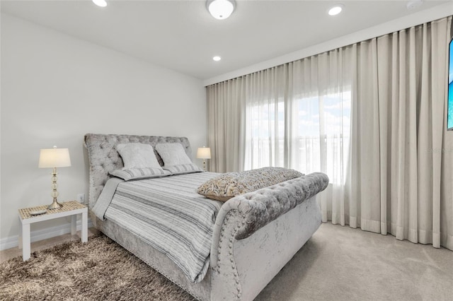 bedroom featuring light carpet