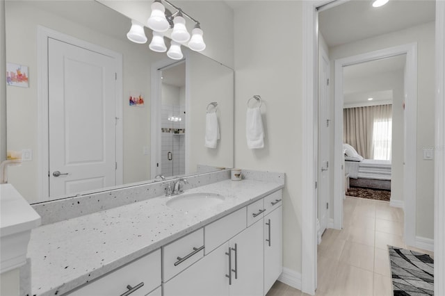 bathroom with tile patterned flooring, vanity, an inviting chandelier, and a shower with door