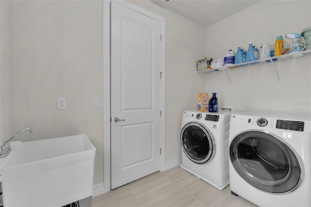 washroom with washing machine and dryer and sink