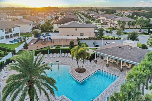 view of pool at dusk