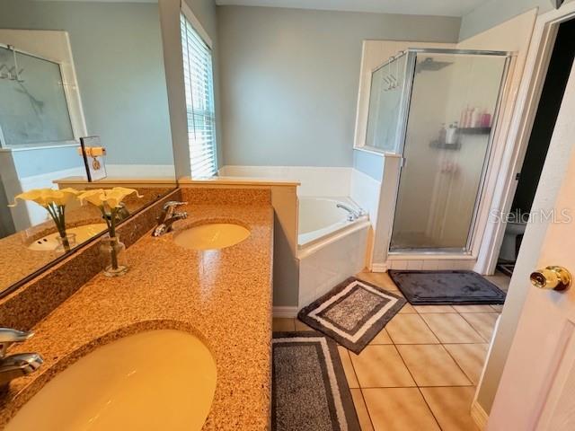 bathroom featuring vanity, separate shower and tub, and tile patterned flooring