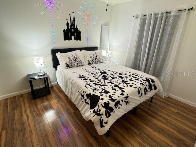 bedroom featuring dark wood-type flooring