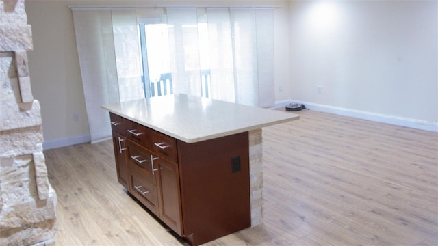 kitchen featuring a kitchen island and light wood-type flooring