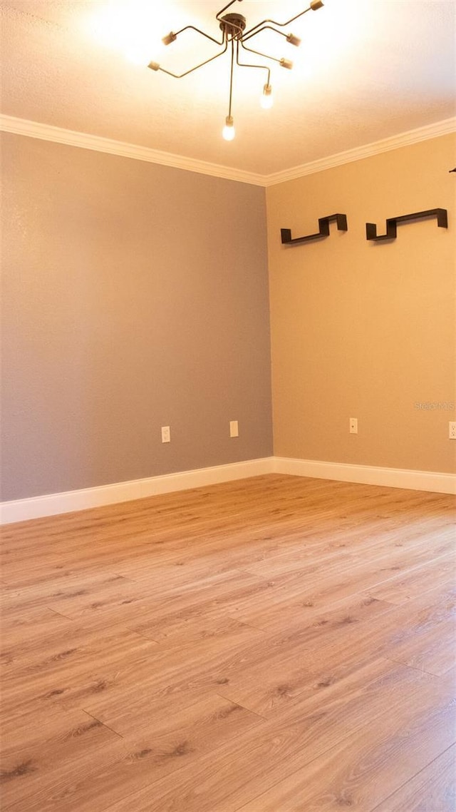 unfurnished room featuring crown molding and hardwood / wood-style flooring