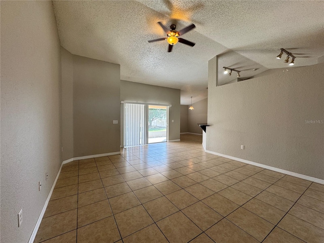 unfurnished room with ceiling fan, lofted ceiling, a textured ceiling, and light tile patterned floors