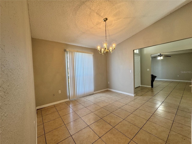 unfurnished room with a textured ceiling, ceiling fan with notable chandelier, light tile patterned floors, and lofted ceiling