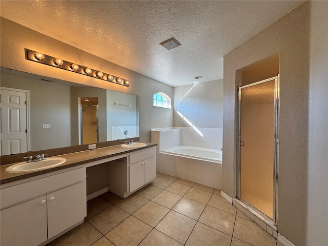 bathroom featuring tile patterned floors, shower with separate bathtub, and a textured ceiling