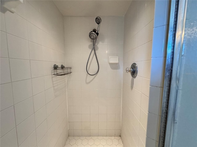 bathroom with a tile shower