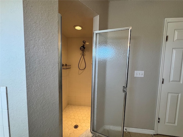 bathroom featuring tile patterned floors and an enclosed shower