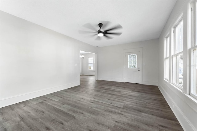 spare room featuring ceiling fan and dark hardwood / wood-style floors