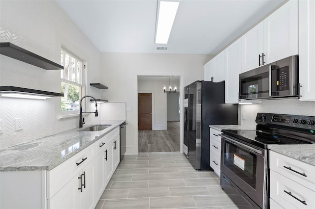 kitchen featuring light hardwood / wood-style floors, stainless steel appliances, sink, and white cabinets