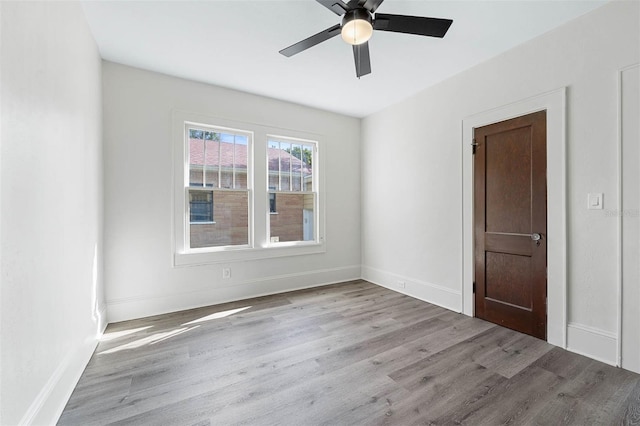 empty room featuring light hardwood / wood-style flooring and ceiling fan