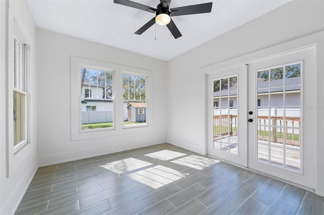 unfurnished room with french doors, a textured ceiling, and ceiling fan