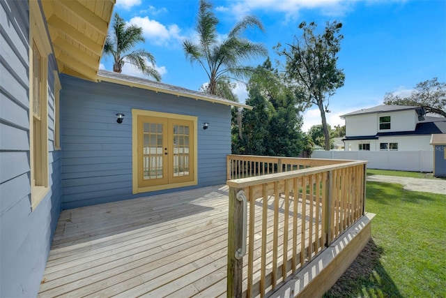 wooden terrace with a yard and french doors