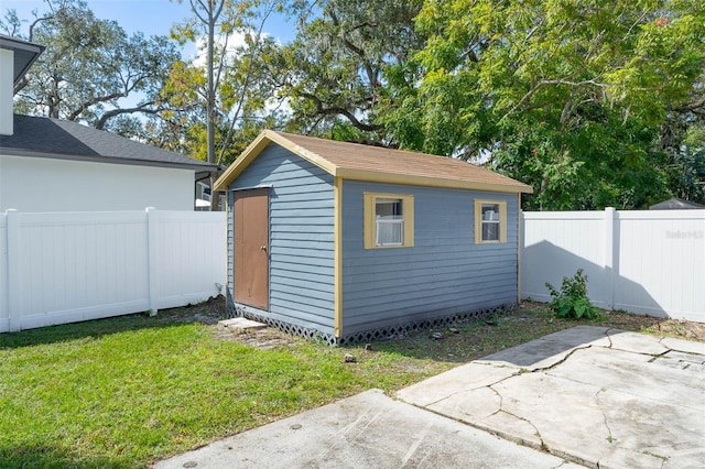 view of outbuilding featuring a lawn