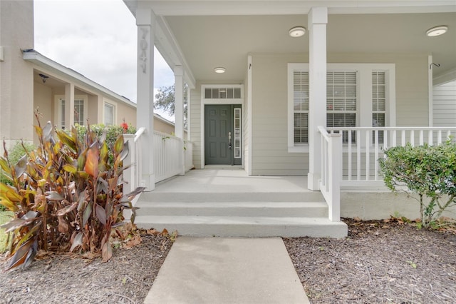 view of exterior entry with covered porch