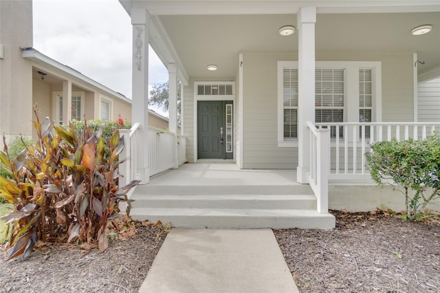 entrance to property featuring a porch