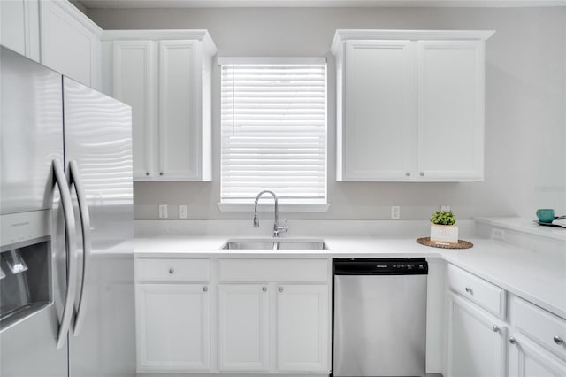 kitchen featuring white cabinetry, a healthy amount of sunlight, stainless steel appliances, and sink