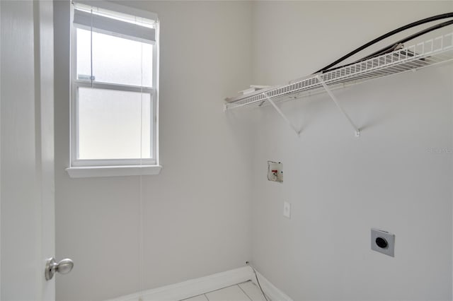 laundry area featuring laundry area, hookup for a washing machine, tile patterned floors, baseboards, and electric dryer hookup
