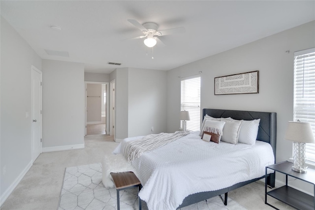 bedroom with light colored carpet and ceiling fan