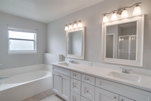 bathroom with vanity, a textured ceiling, tile patterned floors, and separate shower and tub