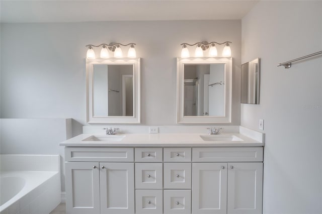 bathroom featuring double vanity, a sink, walk in shower, and tiled tub
