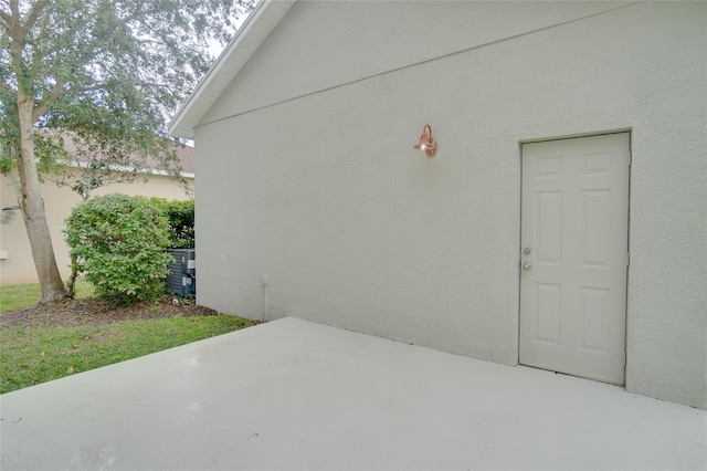 exterior space featuring a patio area and stucco siding