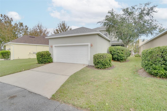 view of front of house featuring an attached garage, stucco siding, a front yard, and concrete driveway