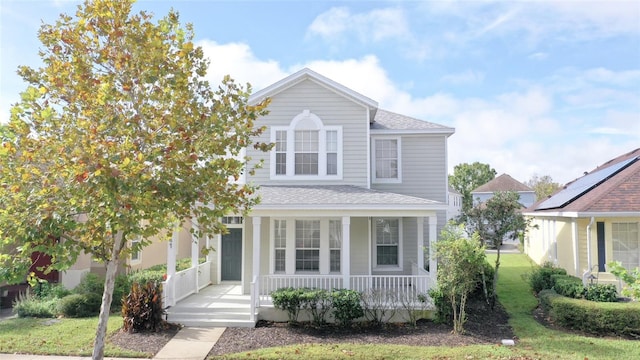 front of property featuring a front lawn and covered porch